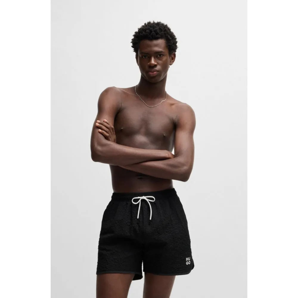 Waffle-structured swim shorts with embroidered stacked logo