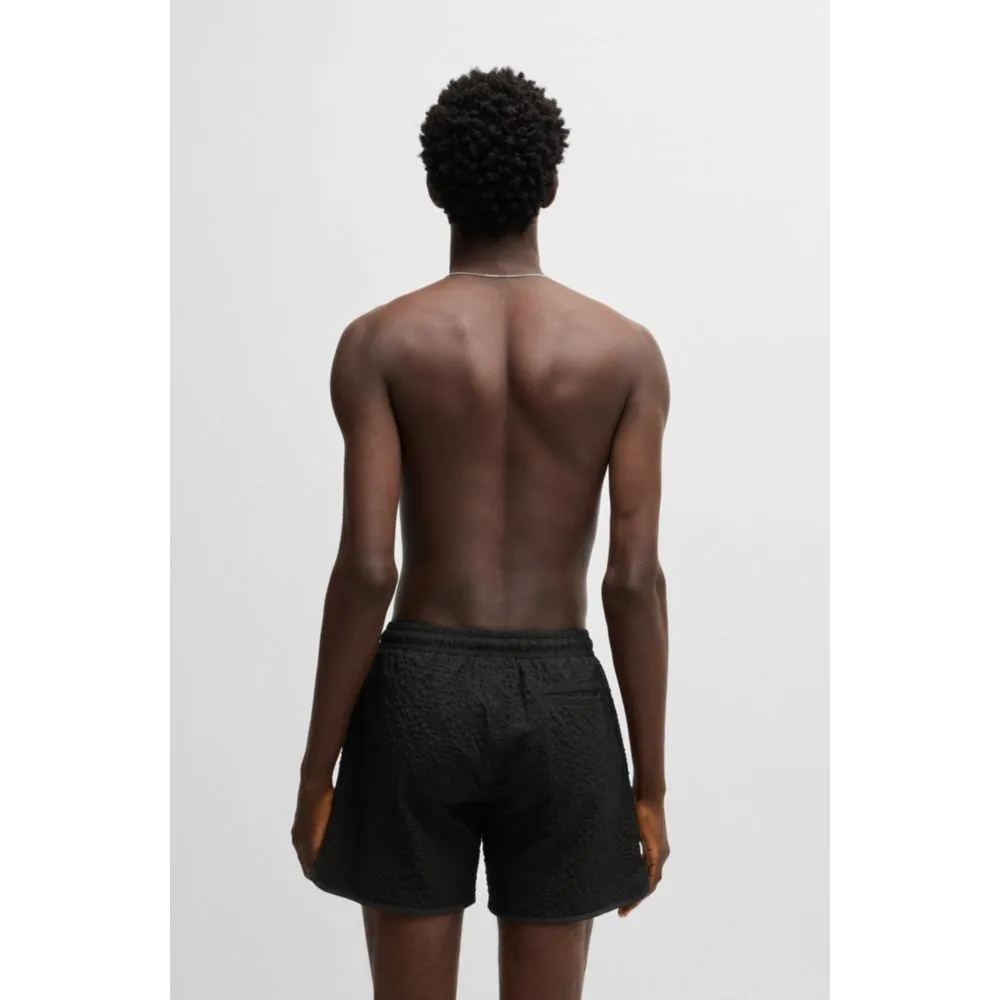 Waffle-structured swim shorts with embroidered stacked logo